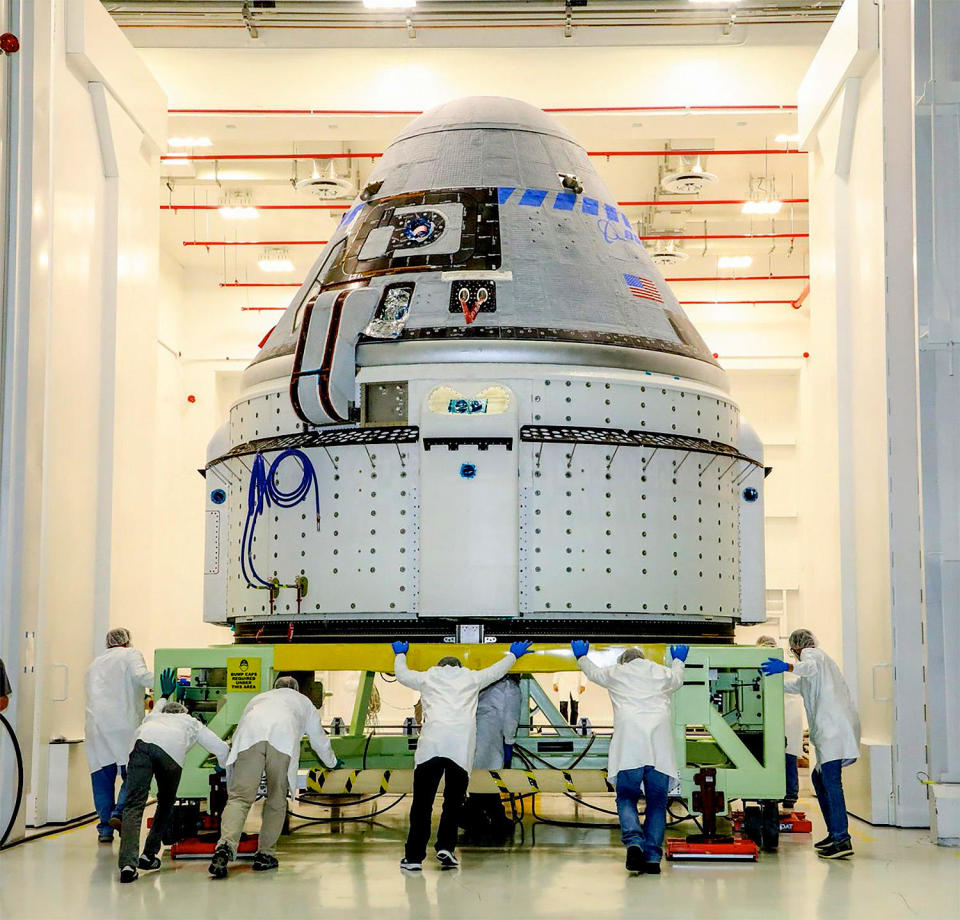 A Starliner capsule and its service module during processing at Boeing's assembly hangar at the Kennedy Space Center before an earlier unpiloted test flight (file photo). / Credit: NASA