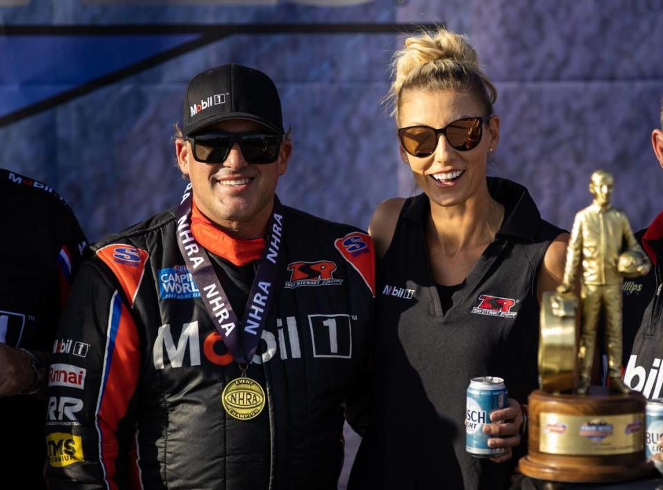 Apr 16, 2023; Las Vegas, NV, USA; NHRA top alcohol dragster driver Tony Stewart (left) celebrates with wife Leah Pruett after winning the Four Wide Nationals at The Strip at Las Vegas Motor Speedway. Mandatory Credit: Mark J. Rebilas-USA TODAY Sports