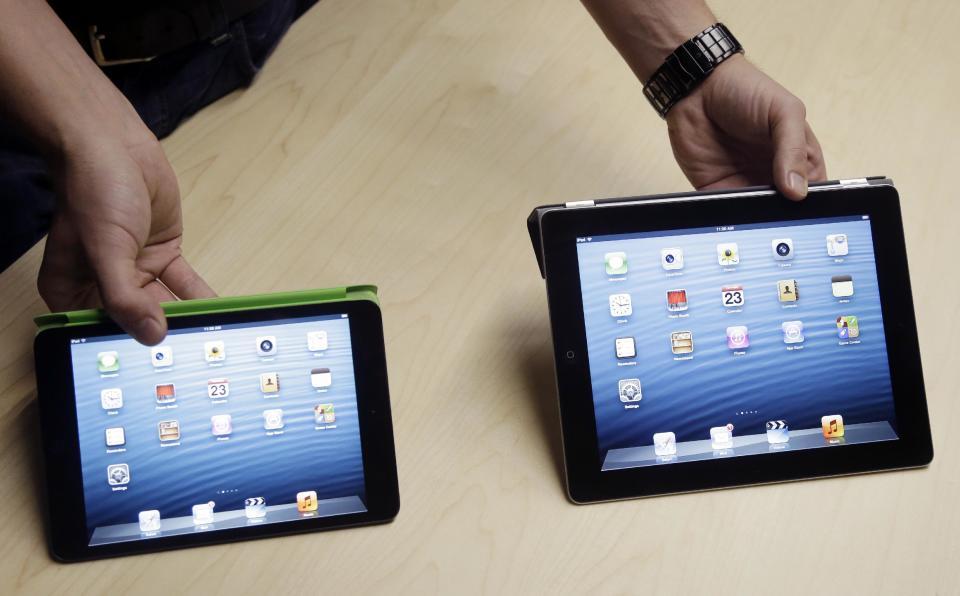 The iPad Mini, at left, is shown next to the 4th Generation iPad in San Jose, Calif., Tuesday, Oct. 23, 2012. Apple Inc. is refusing to compete on price with its rivals in the tablet market, it's pricing its new, smaller iPad well above the competition. On Tuesday, the company revealed the iPad Mini, with a screen that's about two-thirds the size of the full-size model, and said it will cost $329 and up. (AP Photo/Marcio Jose Sanchez)