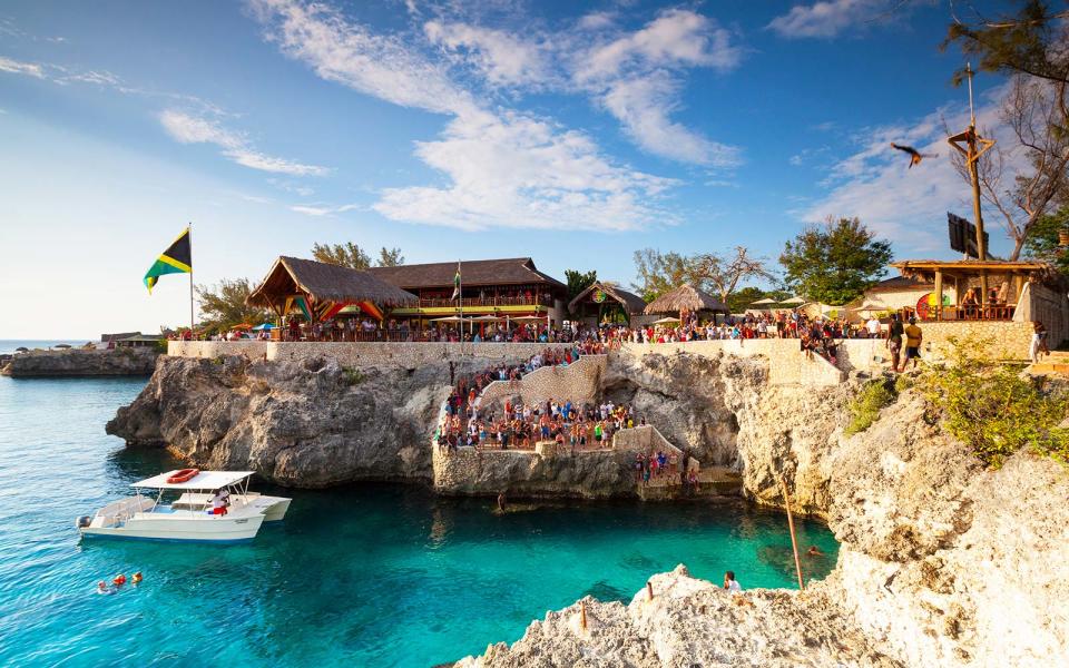 <p>Located on the island’s far Western side, Negril is perfect for honeymooners in search of a lively and picturesque chapter of romance. Sun-basking, reef-swimming and all out-indulging take place in the main, on the golden sands of the famous, sunset-facing <a rel="nofollow noopener" href="http://www.travelandleisure.com/slideshows/best-beaches-jamaica/2" target="_blank" data-ylk="slk:Seven Mile Beach;elm:context_link;itc:0;sec:content-canvas" class="link ">Seven Mile Beach</a>. Negril boasts stylish, boutique hotels atop the stunning limestone cliffs, the most impressive of which is <a rel="nofollow noopener" href="https://www.thecaveshotel.com/" target="_blank" data-ylk="slk:The Caves;elm:context_link;itc:0;sec:content-canvas" class="link ">The Caves</a>. There are also plush beach-front hotels like <a rel="nofollow noopener" href="http://royaltonresorts.com/royalton-negril" target="_blank" data-ylk="slk:Royalton Negril And Hideaway;elm:context_link;itc:0;sec:content-canvas" class="link ">Royalton Negril And Hideaway</a>.</p>
