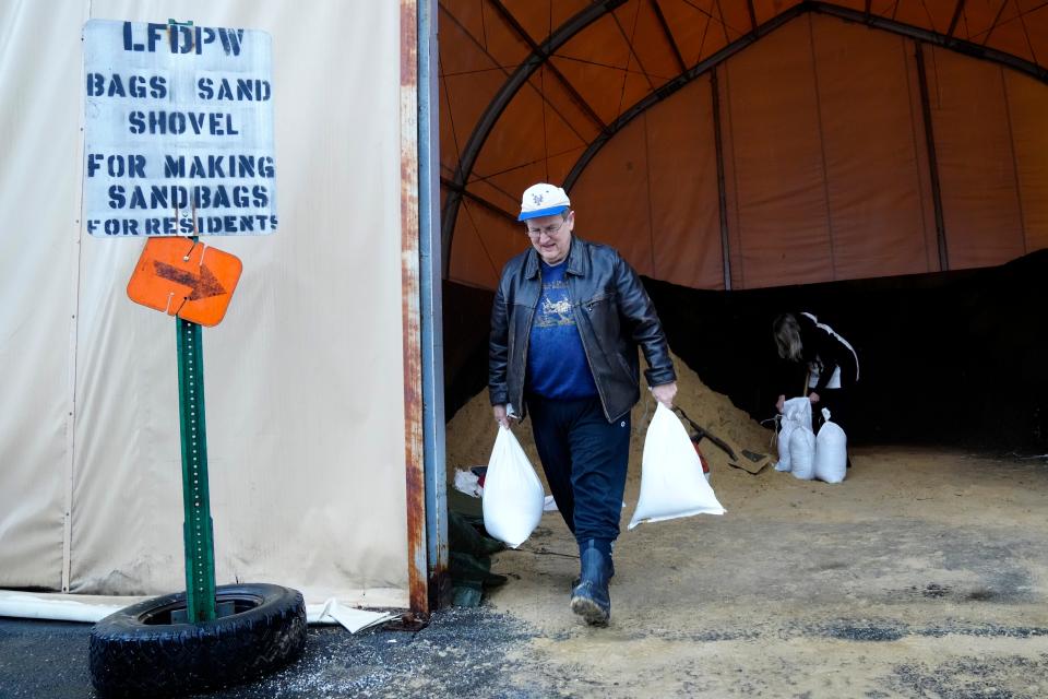 John Jurich, carries sand bags at the Little Falls DPW, Tuesday afternoon, January 9, 2024. Floods are expected in parts of northern New Jersey Wednesday. Jurich, who lives on Amity Street, said of the pending floods, it will be like The Amityville Horror, on his street.