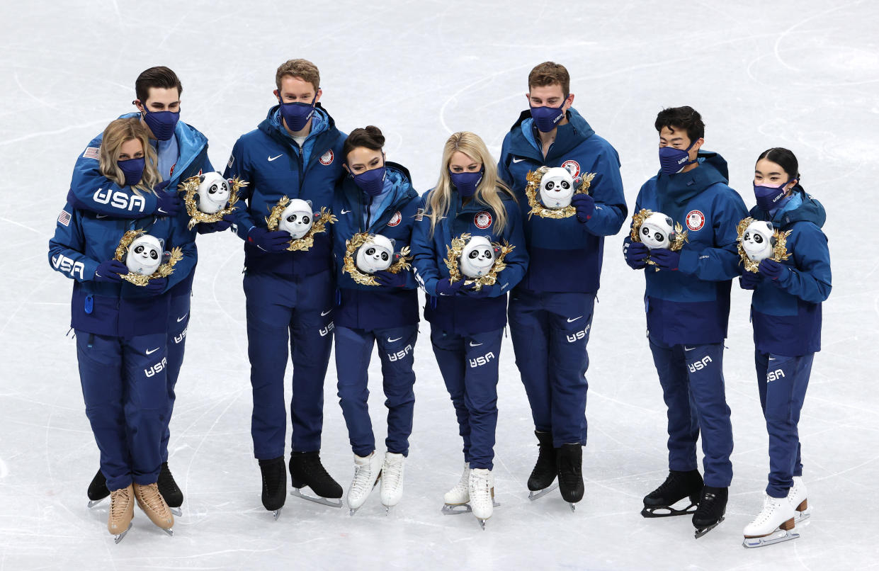 BEIJING, CHINA - FEBRUARY 07: Silver medalists Alexa Knierim, Brandon Frazier, Madison Chock, Evan Bates, Karen Chen, Nathan Chen, Vincent Zhou, Madison Hubbell, Zachary Donohue of Team United States celebrate during the Team Event flower ceremony on day three of the Beijing 2022 Winter Olympic Games at Capital Indoor Stadium on February 07, 2022 in Beijing, China. (Photo by Jean Catuffe/Getty Images)