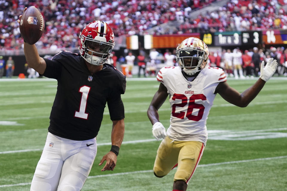 Atlanta Falcons quarterback Marcus Mariota (1) runs into the end zone for a touchdown against San Francisco 49ers cornerback Samuel Womack III (26) during the first half of an NFL football game, Sunday, Oct. 16, 2022, in Atlanta. (AP Photo/John Bazemore)
