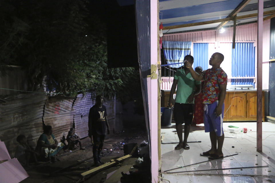 People dismantle their own house to save some material in the Talus 2 district of Koungou, in the French Indian Ocean territory of Mayotte, Saturday, April 22, 2023. France is facing a migration quagmire on the island territory of Mayotte off Africa’s east coast. The government sent in 2,000 troops and police to carry out mass expulsions, destroy slums and eradicate violent gangs. But the operation has become bogged down and raised concerns of abuse, aggravating tensions between local residents and immigrants from the neighboring country of Comoros. (AP Photo/Gregoire Merot)