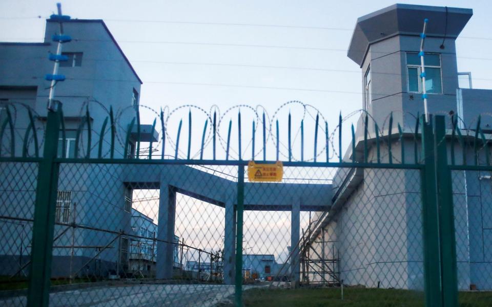 A perimeter fence around what is officially known as a vocational skills education centre in Xinjiang - Reuters