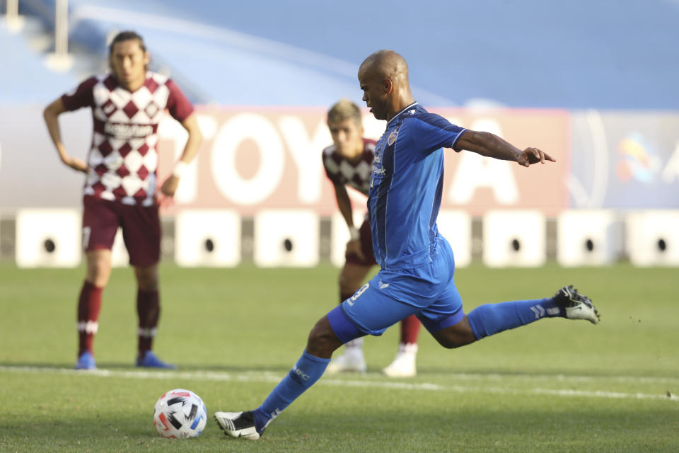 Ulsan Hyundai's Júnior Negrão scores his side's second goal from penalty spot during the Champions League semifinal soccer match between Vissel Kobe and Ulsan Hyundai FC at Jassim Bin Hamad Stadium in Doha, Qatar, Sunday, Dec. 13, 2020. (AP Photo/Hussein Sayed)