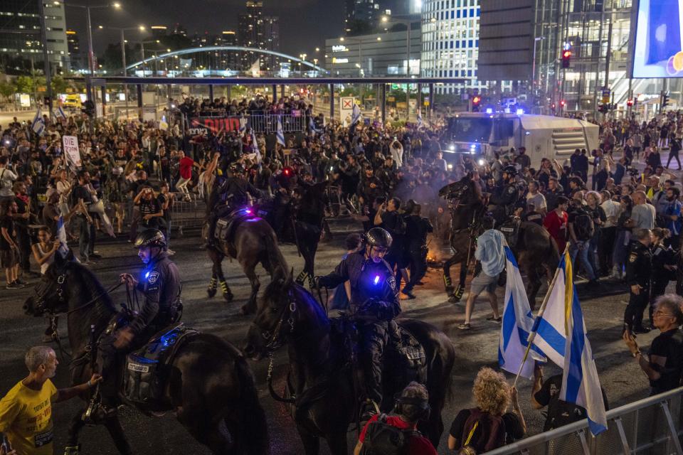 Police use horses to disperse demonstrators during a protest against Israeli Prime Minister Benjamin Netanyahu's government, and calling for the release of hostages held in the Gaza Strip by the Hamas militant group, in Tel Aviv, Israel, Sunday, May 26, 2024. (AP Photo/Ariel Schalit)