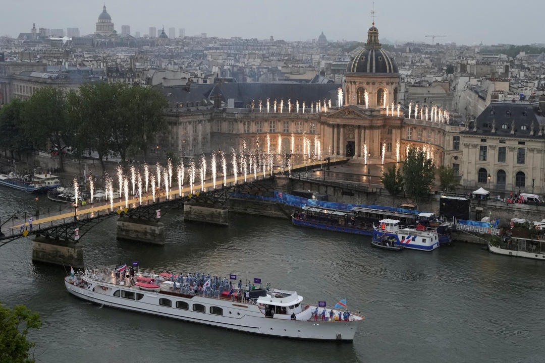 Paris 2024 Olympics - Opening Ceremony - Paris, France - July 26, 2024. Athletes travel by boat along the Seine river during the opening ceremony of the 2024 Summer Olympics. Ricardo Mazalan/Pool via REUTERS