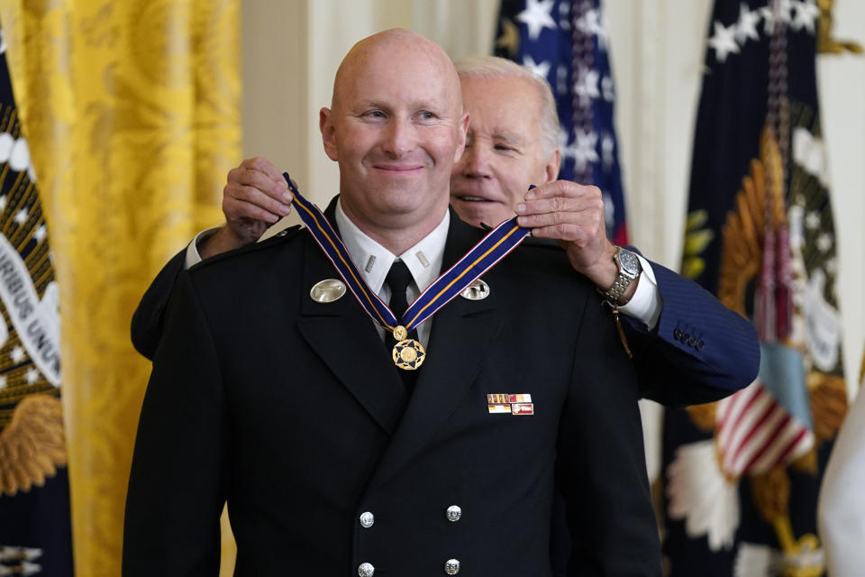 President Joe Biden presents the Medal of Valor, the nation's highest honor for bravery by a public safety officer, to Lt. Justin Hespeler, of the New York City Fire Dept., during an event in the East Room of the White House, Wednesday, May 17, 2023, in Washington. (AP Photo/Evan Vucci)