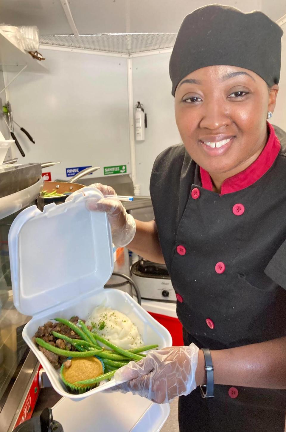 Dee Glover serves up ribeye steak strips served with mashed potatoes, sauteed green beans and brown sugar cornbread from the Signature Flavors Cafe & Catering food truck she owns with her husband, Ronnie.