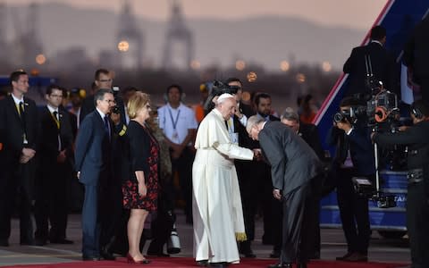 Pope Francis is greeted by Peru's President Pedro Pablo Kuczynski before boarding the plane back to Rome - Credit: AFP