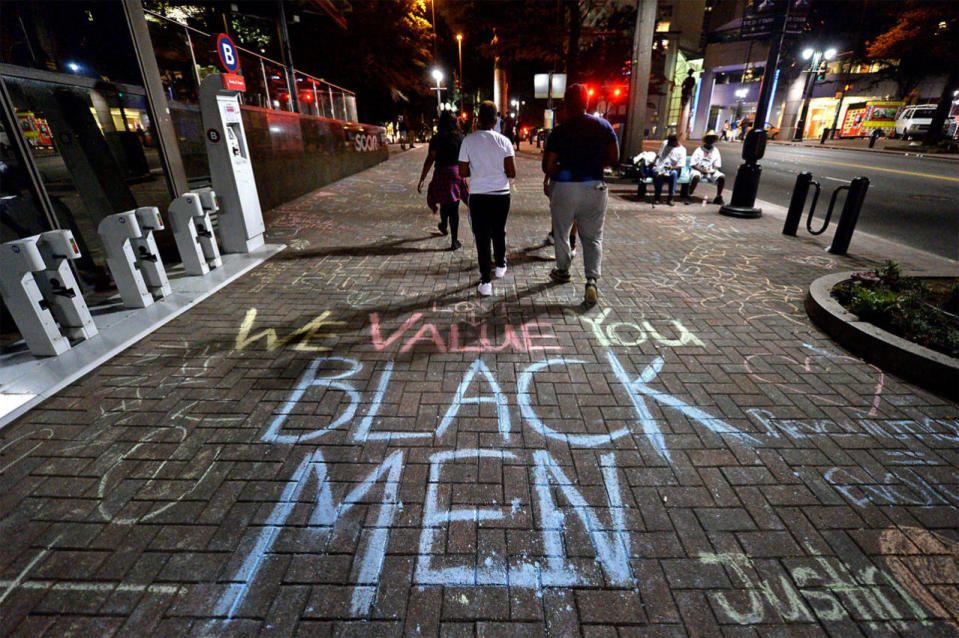 <p>Protesters have used chalk to write slogans and messages on the pavement near the Omni Hotel in Charlotte, N.C., Saturday, Sept. 24, 2016. Protesters came together for the fifth night to protest Tuesday’s fatal police shooting of Keith Lamont Scott. (Jeff Siner/The Charlotte Observer via AP)</p>