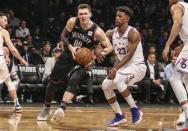 Apr 18, 2019; Brooklyn, NY, USA; Brooklyn Nets forward Rodions Kurucs (00) drives past Philadelphia 76ers guard Jimmy Butler (23) in the third quarter in game three of the first round of the 2019 NBA Playoffs at Barclays Center. Mandatory Credit: Wendell Cruz-USA TODAY Sports