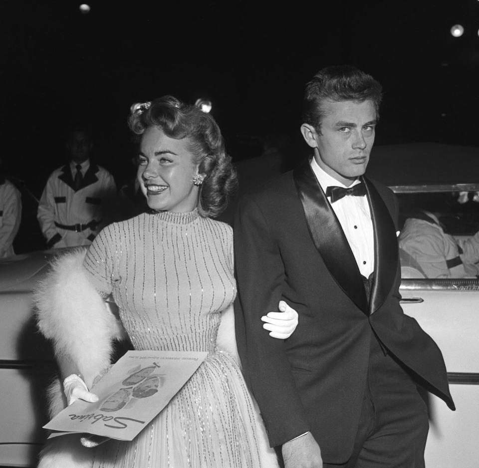 <p>Dean and actress Terry Moore attend the Hollywood premiere of <em>Sabrina </em>together. After the success of <em>East of Eden</em>, Dean was slated to become one of Hollywood's next big stars.  </p>