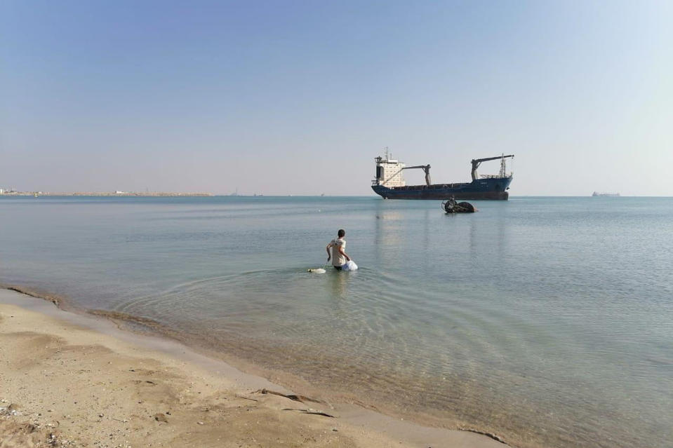 In this photo provided by the International Transport Workers’ Federation, Mohammad Aisha carries bags to the abandoned cargo ship MV Aman in Egyptian waters in March 2021. In 2021 reports surfaced that he was living alone on the ship, forced to swim to shore for food and water. Though he left the ship in 2021, the case is still working its way through the courts three years later. He has not yet been paid, the ITF said. (ITF via AP)