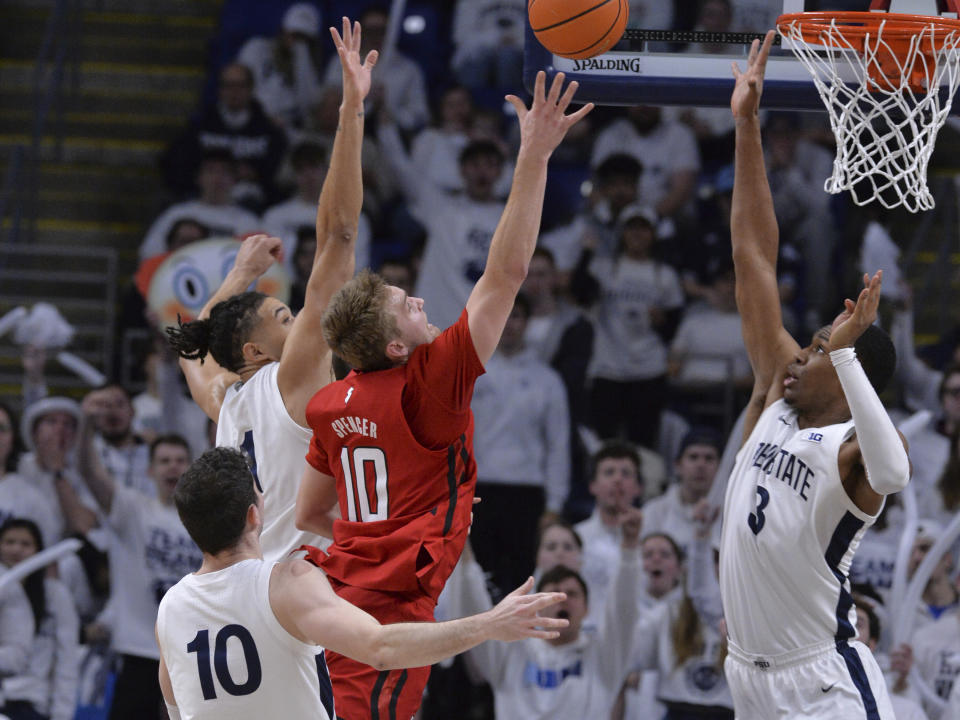 Penn State's Kebba Njie (3) defends against Rutgers' Cam Spencer (10) during the first half of an NCAA college basketball game, Sunday, Feb. 26, 2023, in State College, Pa. (AP Photo/Gary M. Baranec)