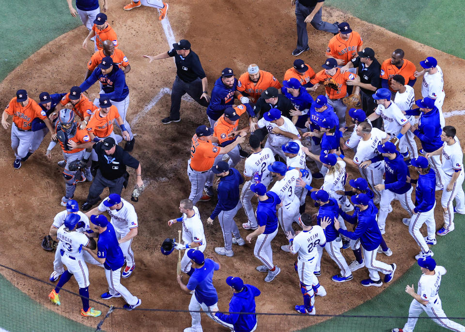 ARLINGTON, TEXAS - OCTOBER 20: Adolis Garcia #53 of the Texas Rangers argues with Martin Maldonado #15 of the Houston Astros after being hit by a pitch by Bryan Abreu #52 of the Houston Astros causing benches to clear during the eighth inning in Game Five of the American League Championship Series at Globe Life Field on October 20, 2023 in Arlington, Texas. (Photo by Carmen Mandato/Getty Images)