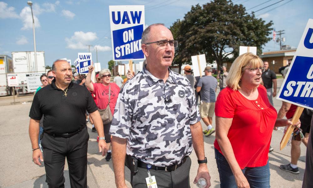 The UAW president, Shawn Fain, center, called for everyone ‘from our friends and families all the way up to the president of the United States’ to ‘join us on the picket line’.