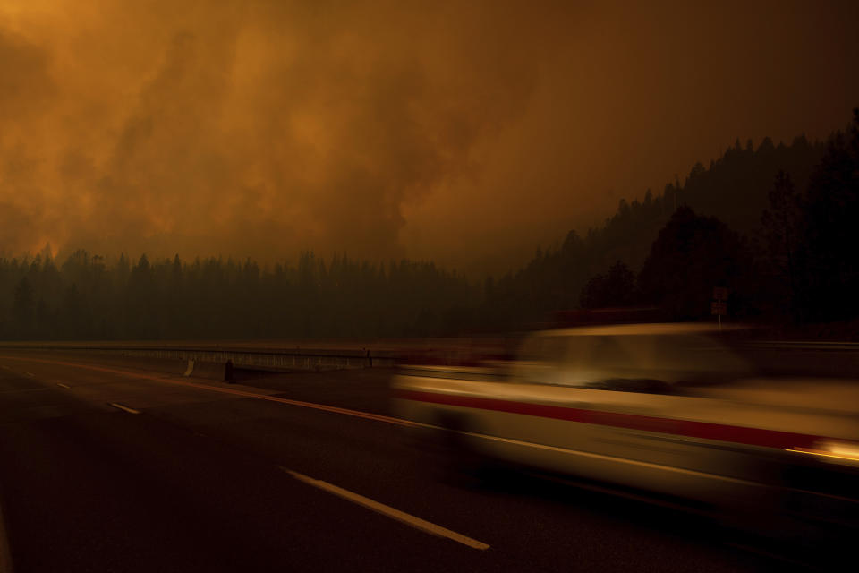 A fire vehicle drives along Interstate 5 as the Delta Fire burns in the Shasta-Trinity National Forest, Calif., on Thursday, Sept. 6, 2018. The highway remains closed in both directions as crews battle the blaze. (AP Photo/Noah Berger)