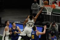 Milwaukee Bucks' Giannis Antetokounmpo shoots over Denver Nuggets' Nikola Jokic during the first half of an NBA basketball game Tuesday, March 2, 2021, in Milwaukee. (AP Photo/Morry Gash)