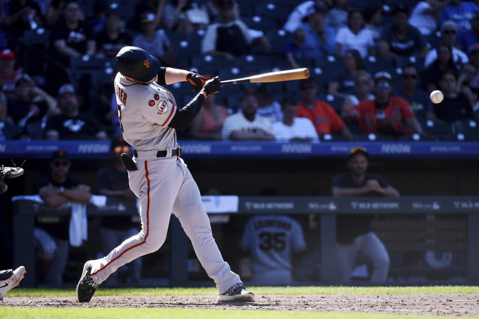 San Francisco Giants' Austin Slater singles in the seventh inning of a baseball game against the Colorado Rockies, Sunday, Sept. 17, 2023, in Denver. (AP Photo/Geneva Heffernan)