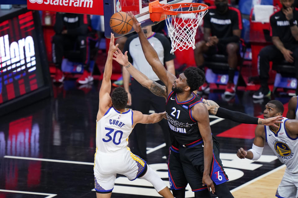 Philadelphia 76ers' Joel Embiid, right, blocks a shot by Golden State Warriors' Stephen Curry during the second half of an NBA basketball game, Monday, April 19, 2021, in Philadelphia. (AP Photo/Matt Slocum)
