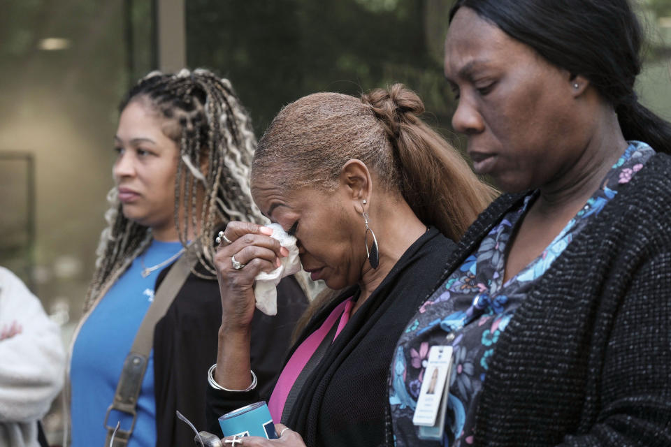 People stand outside a commercial building after a shooting, Wednesday, May 3, 2023, in Atlanta. Atlanta police said there had been no additional shots fired since the initial shooting unfolded inside a building in a commercial area with many office towers and high-rise apartments. (AP Photo/Ben Gray)