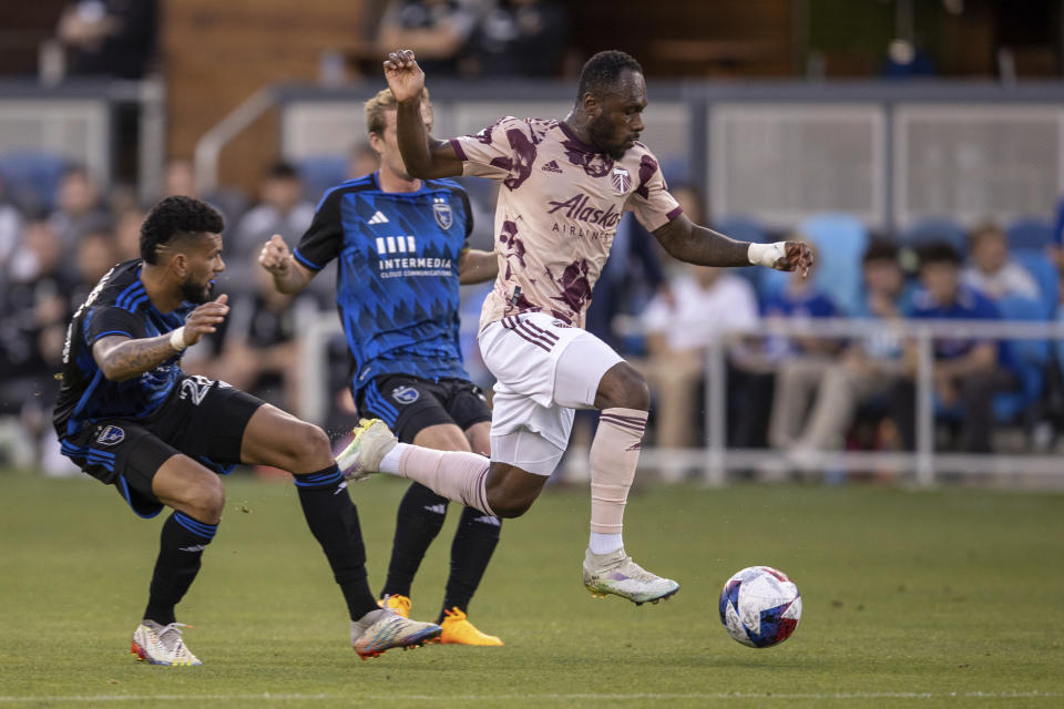 Portland Timbers forward Franck Boli, right, drives past San Jose Earthquakes defender Rodrigues, left, during the first half of an MLS soccer match in San Jose, Calif., Saturday, June 17, 2023. (AP Photo/John Hefti)