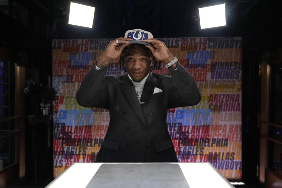 Florida quarterback Anthony Richardson puts on a hat after being chosen by the Indianapolis Colts with the fourth overall pick during the first round of the NFL football draft, Thursday, April 27, 2023, in Kansas City, Mo. (AP Photo/John Locher)