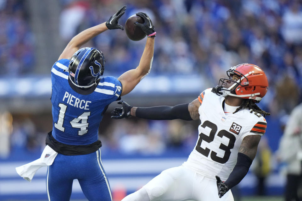 Indianapolis Colts wide receiver Alec Pierce (14) catches a pass over Cleveland Browns cornerback Martin Emerson Jr. (23) during the second half of an NFL football game, Sunday, Oct. 22, 2023, in Indianapolis. (AP Photo/AJ Mast)