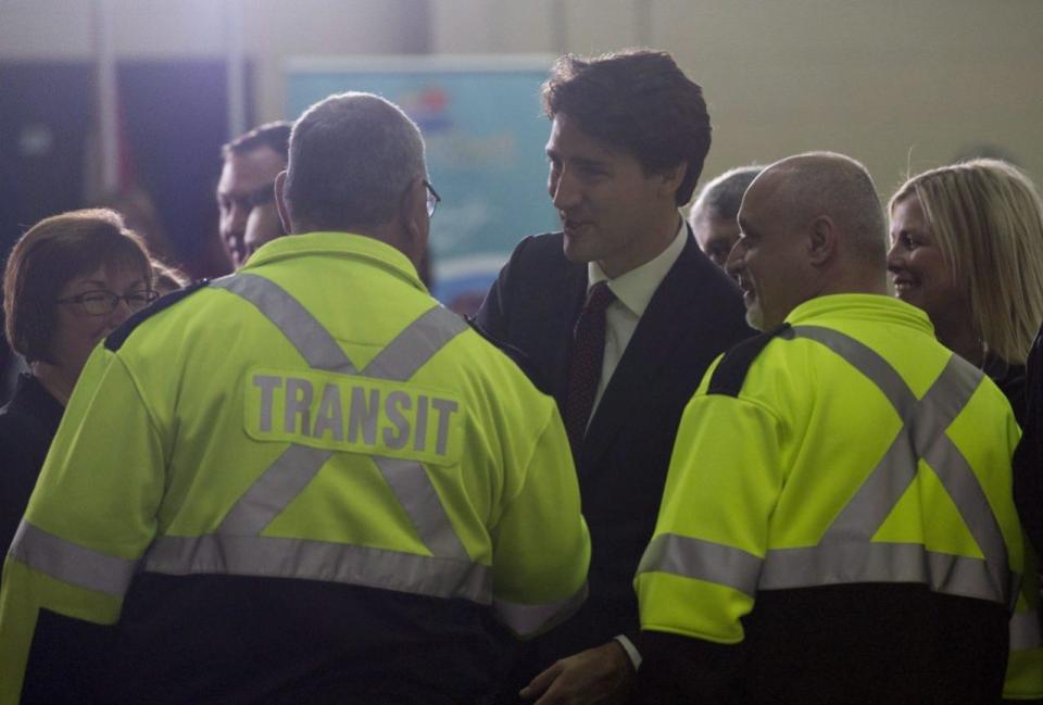 Prime Minister Justin Trudeau speaks with transit employees following an announcement in Sault Ste. Marie, Ont., on Friday, April 8, 2016. THE CANADIAN PRESS/Adrian Wyld