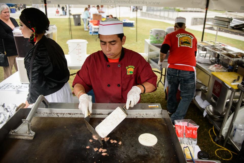 In this 2014 file photo, Julian Cisneros cooks up steak at the El Cazador booth during the Taste of Fayetteville event at Festival Park.