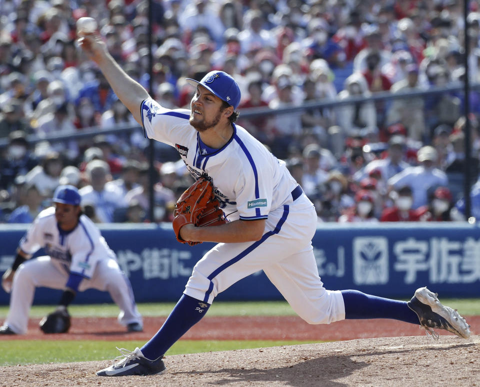 Yokohama DeNA BayStars pitcher Trevor Bauer delivers a pitch against Hiroshima Carp during baseball game in Yokohama, near Tokyo, Wednesday, May 3, 2023. After cheerleaders welcomed him, after receiving the largest ovation of any Yokohama player at the start of the game, Bauer delivered what was expected on Wednesday in his debut with the Yokohama DeNA Baystars.(Kyodo News via AP)