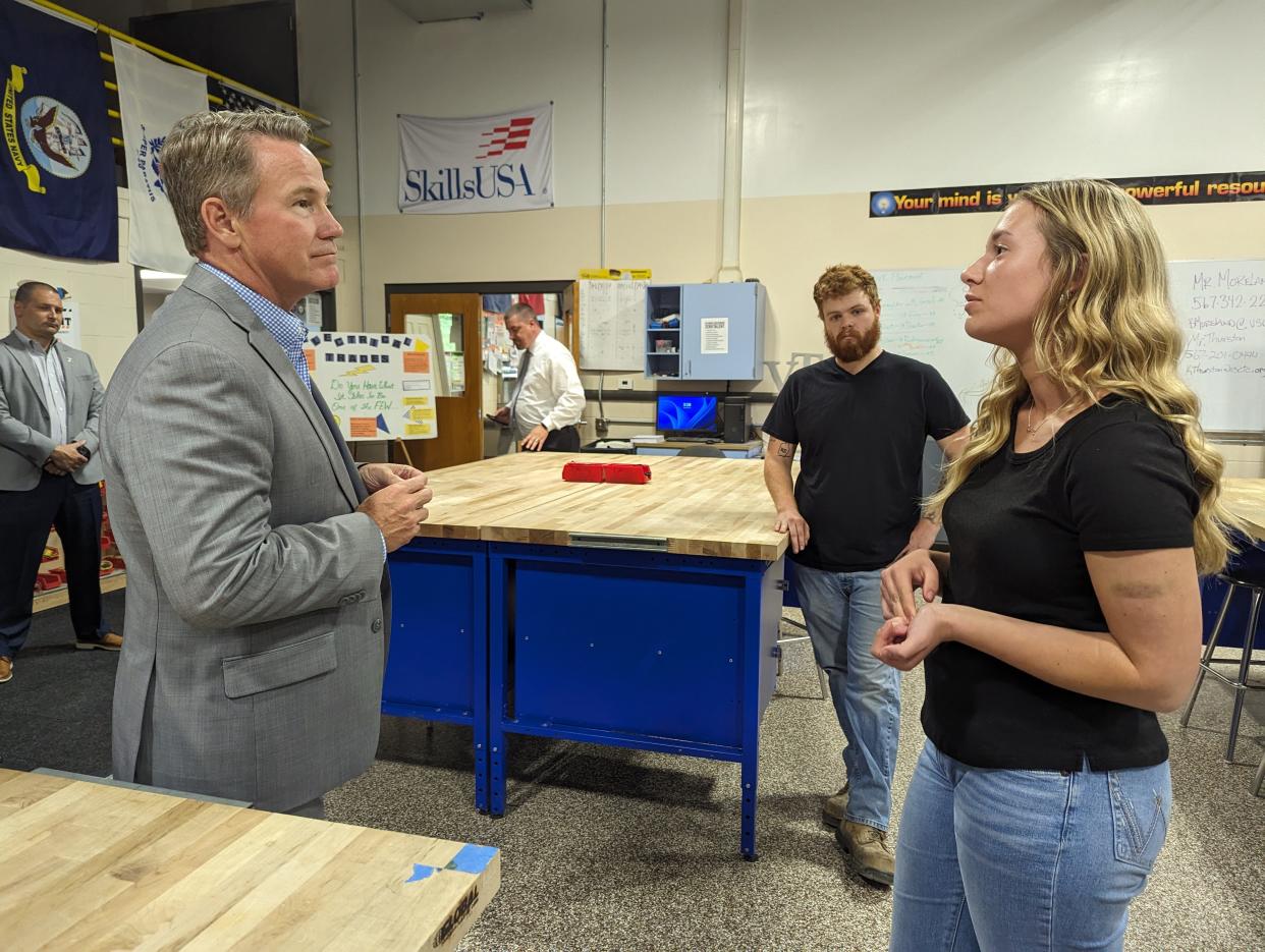 Lt. Gov. Jon Husted, left front, visited the Fremont campus of the Vanguard Sentinel Career and Technology Center on Wednesday. He speaks with Olivia Konves, right, who is studying the electrical trades.