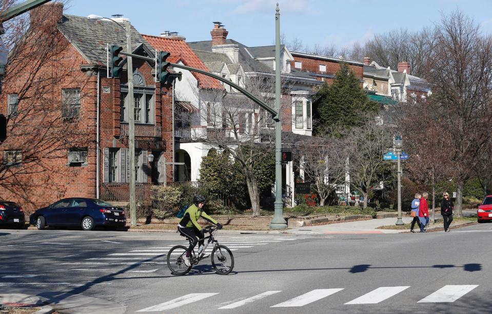 Cyclists and pedestrians cross The Boulevard in Richmond, Virginia.