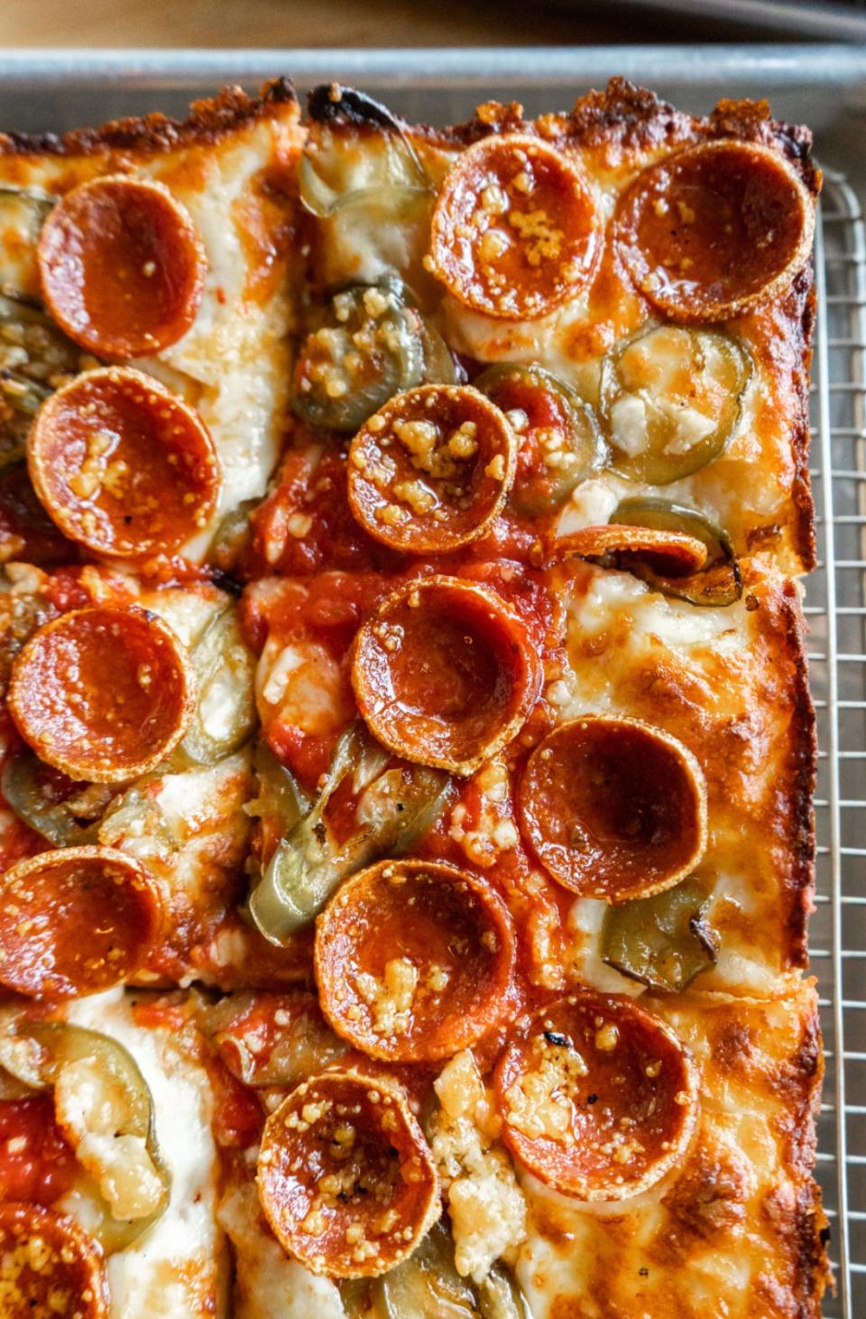 A closeup of a Detroit-style deep dish pizza.