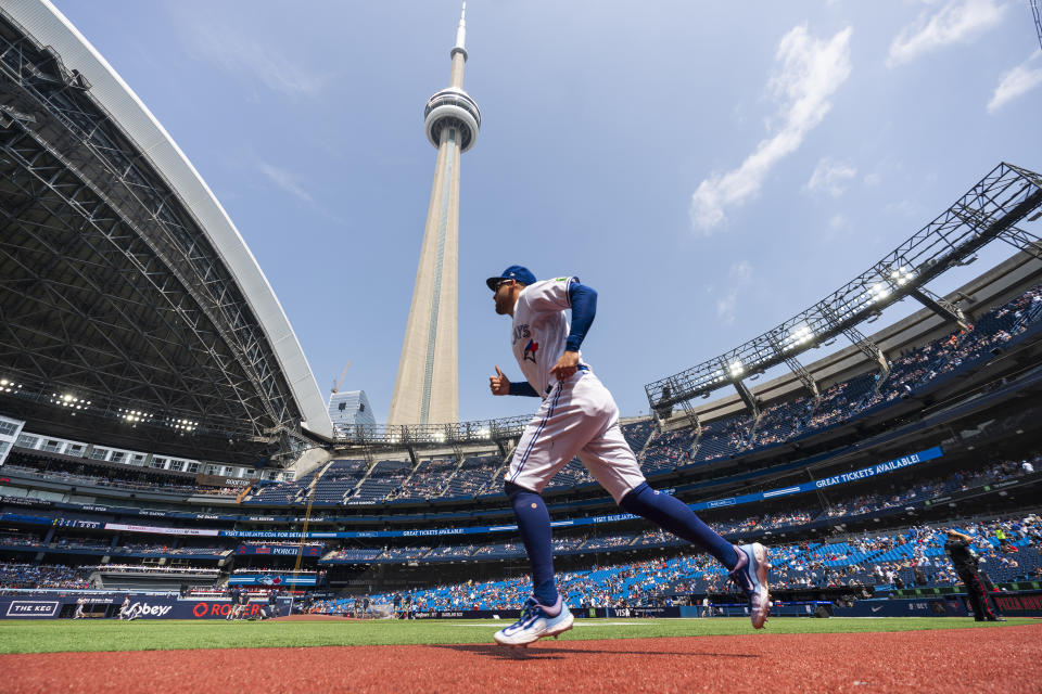 Toronto Blue Jays right fielder George Springer (4) runs on the field with the CN Tower in the background before playing the Baltimore Orioles in a baseball game in Toronto, Thursday Aug. 3, 2023. (Mark Blinch/The Canadian Press via AP)