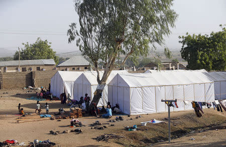 People displaced as a result of Boko Haram attacks in the northeast region of Nigeria, are seen near their tents at a faith-based camp for internally displaced people (IDP) in Yola, Adamawa State January 14, 2015. REUTERS/Afolabi Sotunde