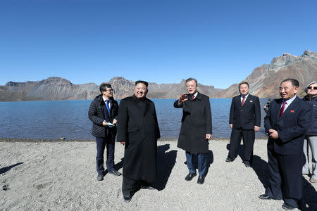 South Korean President Moon Jae-in and North Korean leader Kim Jong Un talk beside the Heaven Lake of Mt. Paektu, North Korea, September 20, 2018. Pyeongyang Press Corps/Pool via REUTERS