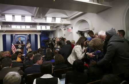 President Barack Obama (L) watches as journalists aid a colleague (2R) who collapsed in the White House press briefing room and help escort her to the doctor during Obama's last news conference of the year in Washington, U.S., December 16, 2016. REUTERS/Carlos Barria