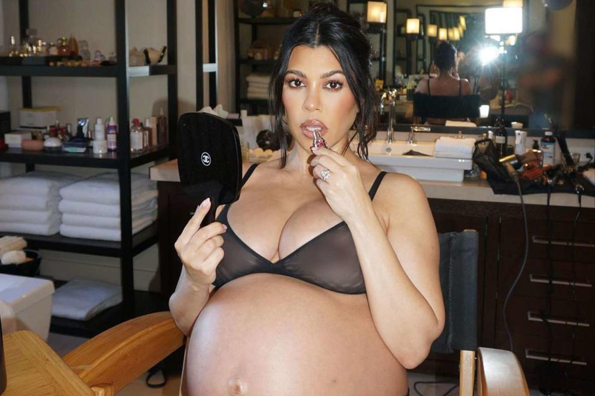 Pregnant Kourtney Kardashian Wears Sheer Bra and Applies Lip Gloss