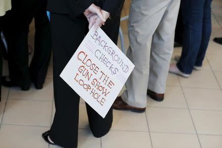 An audience member holds a hand lettered sign calling for further gun control at a campaign stop with U.S. Democratic presidential candidate Hillary Clinton in Nashua, New Hampshire October 16, 2015. REUTERS/Brian Snyder