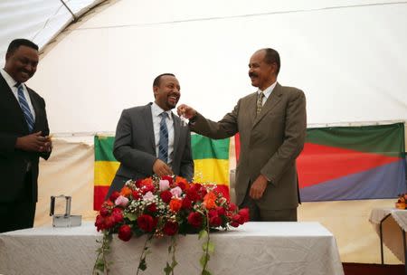 Eritrea's President, Isaias Afwerki receives a key from Ethiopia's Prime Minister, Abiy Ahmed during the Inauguration ceremony marking the reopening of the Eritrean Embassy in Addis Ababa, Ethiopia July 16, 2018. REUTERS/Tiksa Negeri