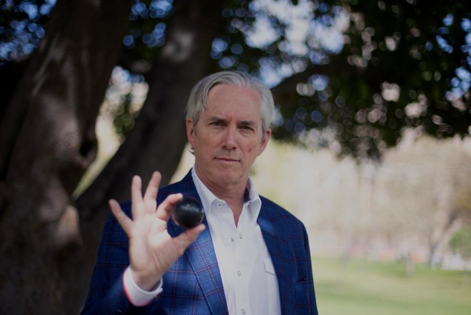 J. Clay Sell, CEO of X-energy, holds a billiards ball-sized model of a uranium "pebble," capable of fueling scalable nuclear reactors with reduced costs and heightened safety, in Austin on March 10, 2024.