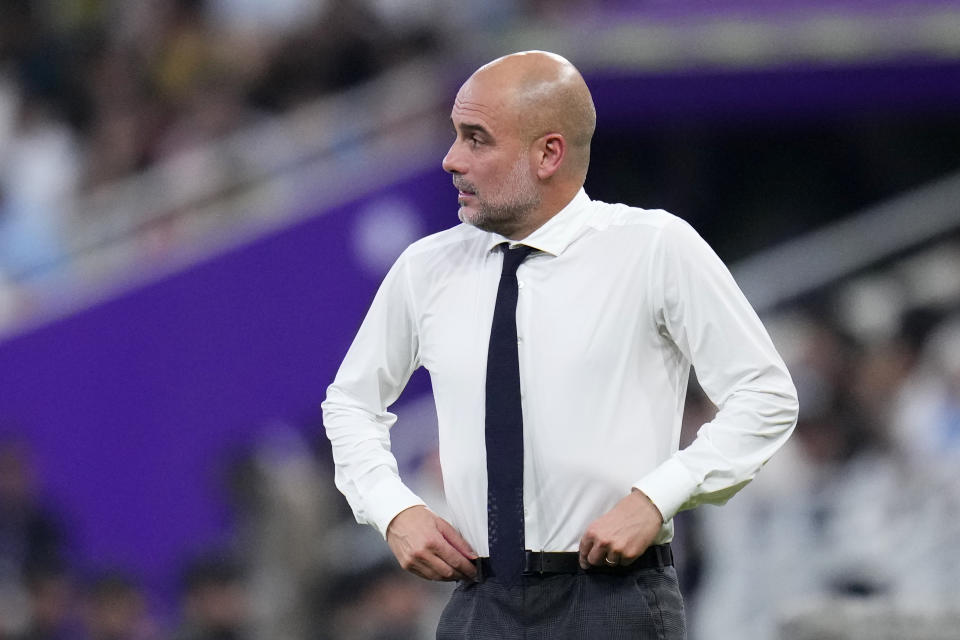 Manchester City's head coach Pep Guardiola pulls up his pants during the Soccer Club World Cup final match between Manchester City FC and Fluminense FC at King Abdullah Sports City Stadium in Jeddah, Saudi Arabia, Friday, Dec. 22, 2023. (AP Photo/Manu Fernandez)