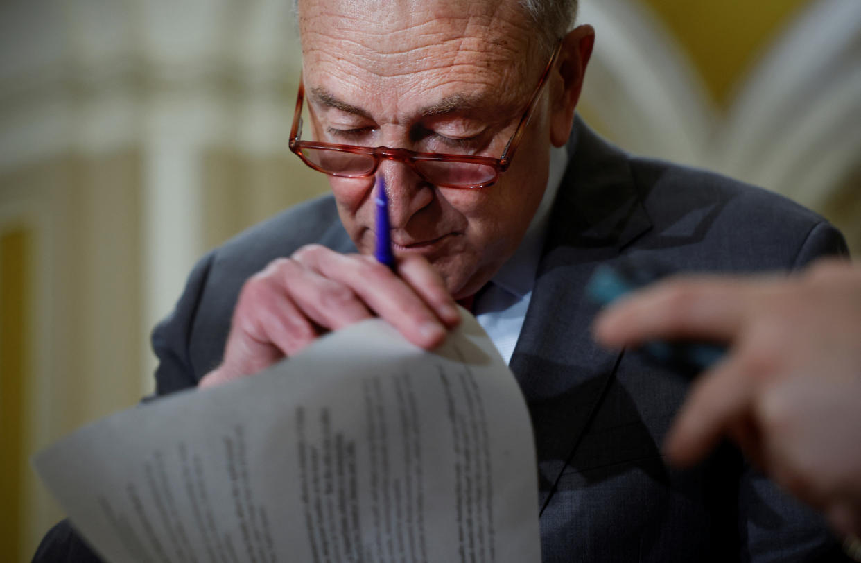 Senate Majority Leader Chuck Schumer, D-N.Y., looks at his notes during the weekly Democratic Party caucus luncheon at the U.S. Capitol in Washington, D.C., on March 28.