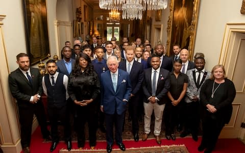 Prince Charles and Prince Harry pose for a photograph following a discussion about violent youth crime  - Credit: PA