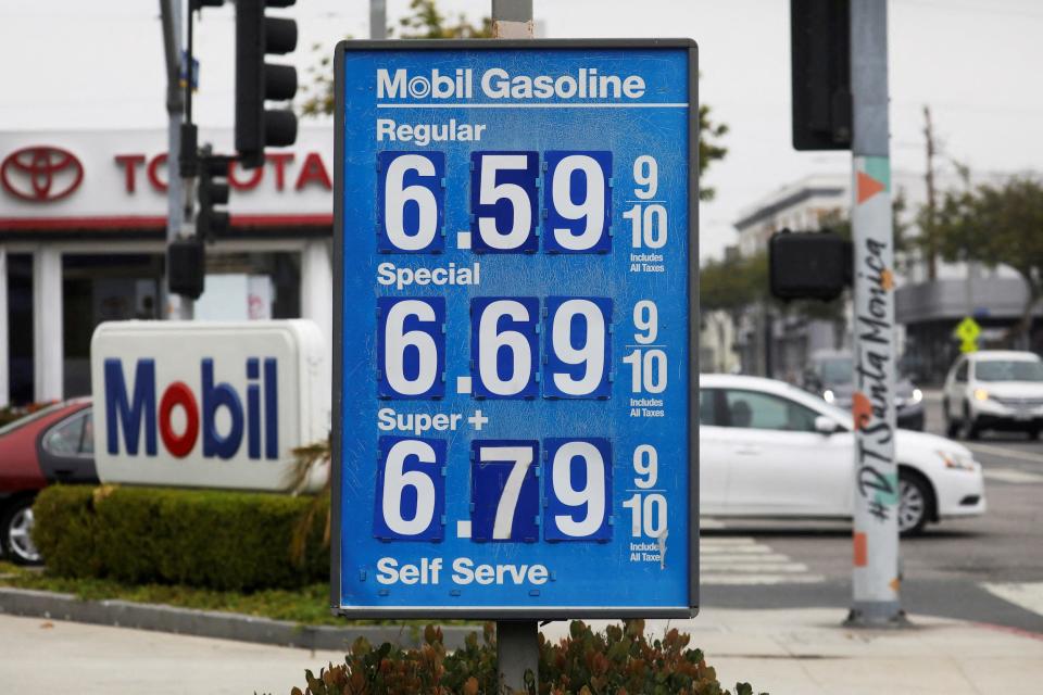blue gas station sign shows prices above six dollars