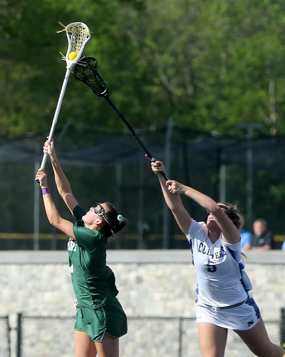 Duxbury's Ellie Wall wins the face-off draw over Norwell's Danielle Cox during their game at the Norwell Clipper Community Complex on Friday, May 12, 2023.