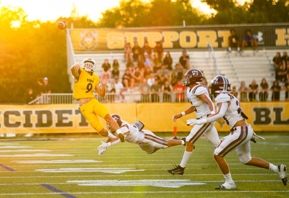Bishop Verot Vikings quarterback Carter Smith (9) throws the ball as a First Baptist Academy Lions defender dives for him during the first quarter of a game at Bishop Verot High School in Fort Myers on Friday, Sept. 15, 2023.